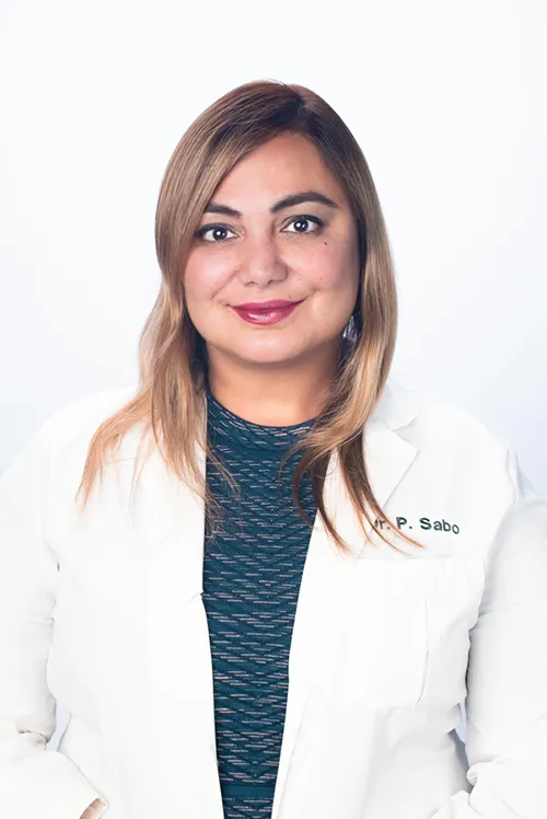 A woman with light brown hair, identified as Dr. Arian Mowlavi, wears a white lab coat and a dark patterned shirt as she poses against a plain white background.